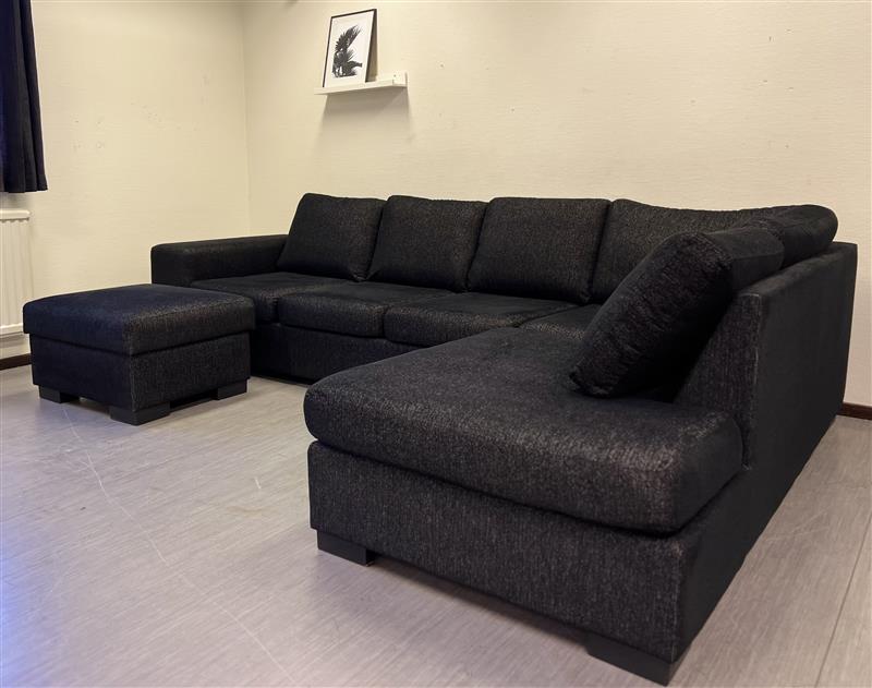 Svart divansoffa med pall